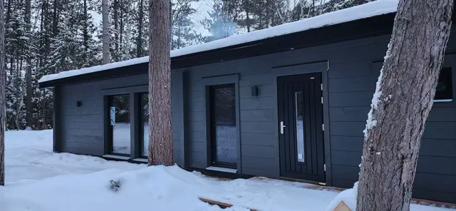 Chalet Levätä covered in winter snow